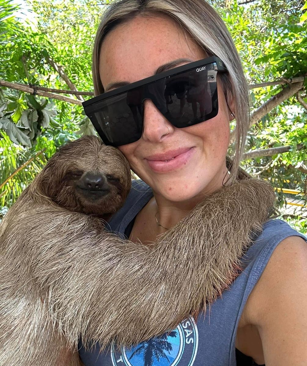 Guest holding a sloth in Roatán